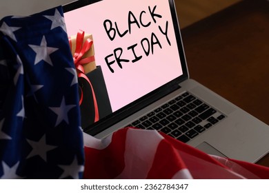 black friday on laptop next to american flag - Powered by Shutterstock