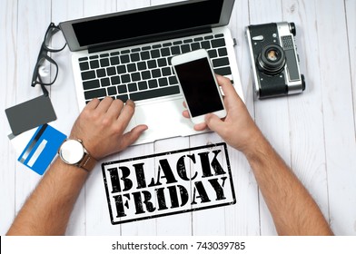 Black Friday. Online Shopping Concept. Man Holding Credit Card And Using Laptop Computer.