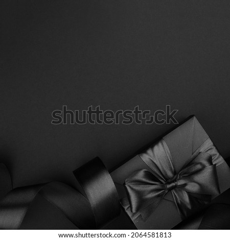 Black friday sale background with gift present box and curly ribbon with copy space for text ad