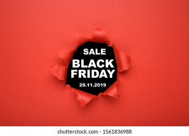 Black Friday sale concept. Top view of red torn paper and text black Friday on black background. Copy space, close up, top view, flat lay