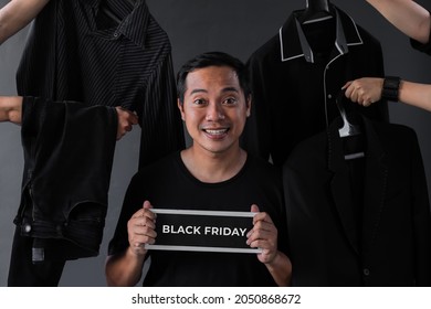 Black Friday Sale promotion with shopaholic man model surounded by black clothes and man accessories 