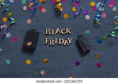 Black Friday Text With Holiday Tinsel Flat Lay On Dark Background.