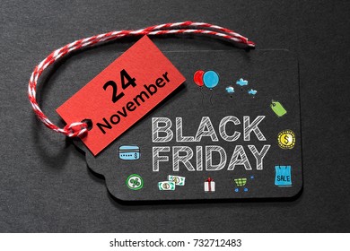 Black Friday text on a black tag with red and white twine