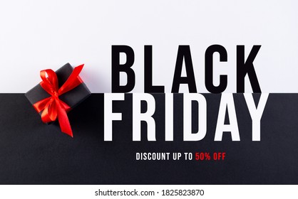 Black Friday. Top view of black christmas boxes with red ribbon on black and white paper background with copy space for text. - Shutterstock ID 1825823870