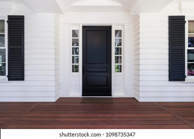Black front door of classic style home in Oregon.