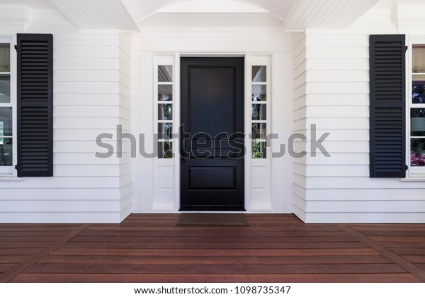 Black front\
door of classic style home in\
Oregon.