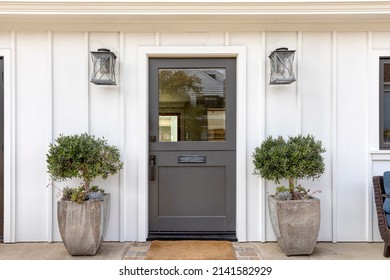 Black Front Door, Front Door Of A House Adorned Two Potted Plants.