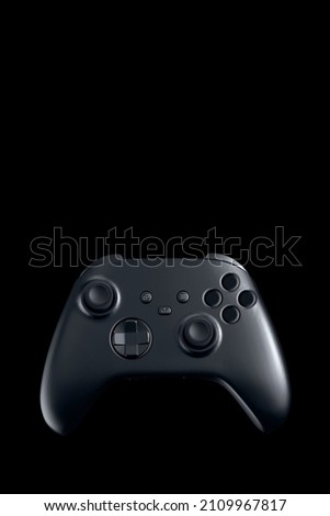 black game controller on black background

