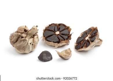 Black garlic bulbs isolated on white background