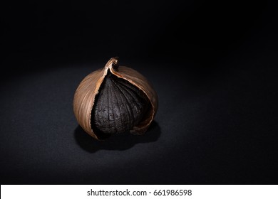 Black garlic on black background with a nice lighting 