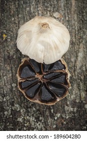 Black garlic on wooden background