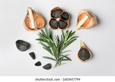 Black Garlic And Rosemary On White Background