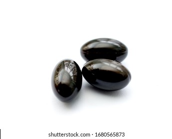 black garlic soft gel capsules supplement on white