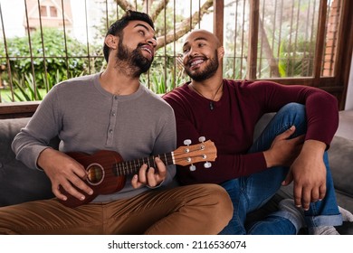 Black Gay Couple Playing Music And Singing In The Sofa