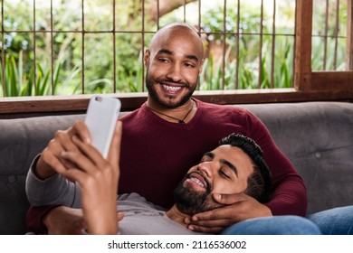 Black Gay Couple Relaxing And Using Mobile Phone For Fun In The Couch