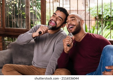 Black Gay Couple Singing Together Karaoke Style In The Couch