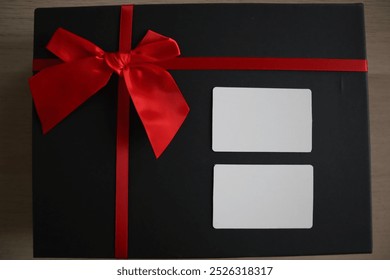 Black gift box with red ribbon and white blank section to write things - Powered by Shutterstock