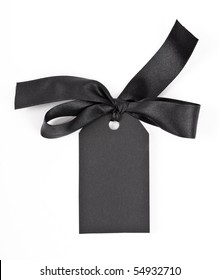 Black Gift Tag Tied With A Bow Of Red Satin Ribbon