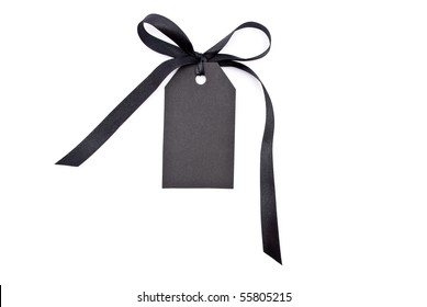 Black Gift Tag Tied With A Bow Of Red Satin Ribbon