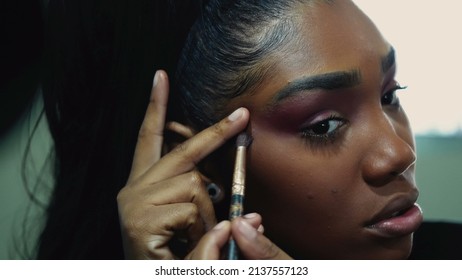 A Black Girl Applying Make-up Preparing To Go Out