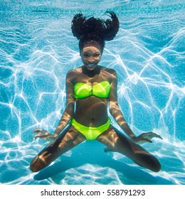 Black Girl Diving In Swimming Pool At Vacation