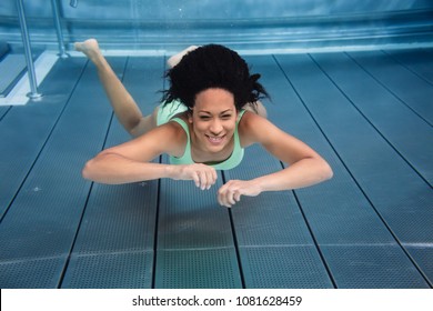 Black Girl Diving Underwater In Swimming Pool