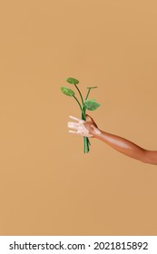 Black Girl Doll  With Viteligo Holds Plant On Yellow Background