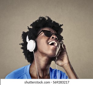 Black Girl Listening To Music And Singing Loudly With Passion