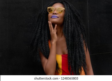 Black Girl Magic Powerful Vivid Portrait With Colored Sunglasses, Purple Lipstick and Giant Braids Marley Hair. Powerful Ethnic Beauty and Style  