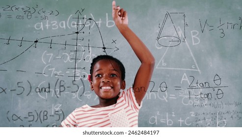 Black girl raises hand by chalkboard with math equations. She has dark hair, a bright smile, and is wearing a casual pink top - Powered by Shutterstock