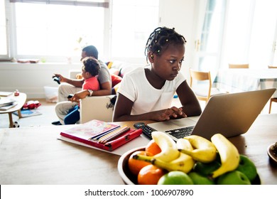 Black Girl Using Laptop At Home