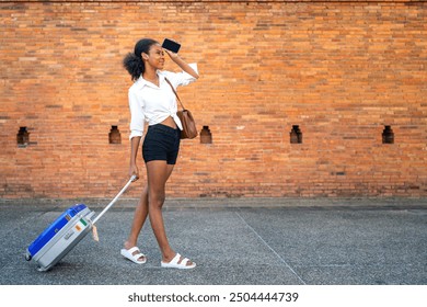 black girl using phone ancient area finding location on holiday. african american girl searching for landmark of brick wall. female teenage tourist holding baggage looking for chiangmai gateway view. - Powered by Shutterstock