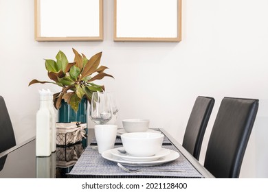 Black Glass Dining Table With Service For Two In A Vacation Rental Apartment