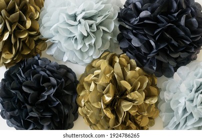 Black, Gold And Blue Poms On White Background. Celebration Decor Concept