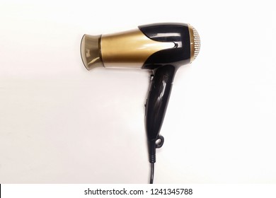 Black and gold hair dryer isolated white background.