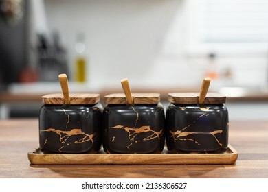 Black And Gold Spice Container On A Wooden Countertop In A Kitchen 