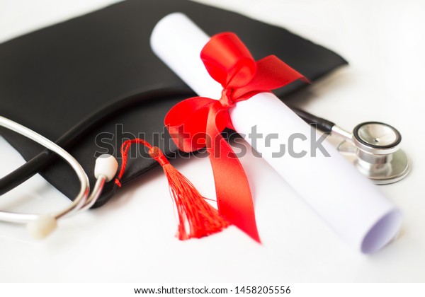 Black graduation\
cap, degree and stethoscope\
