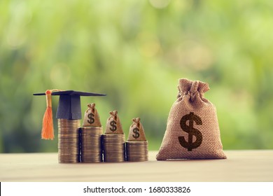 Black Graduation Cap, Hat And US Dollar Bag On Rows Of Rising Coins,  On A Table. Education Funding, Financial Concept. Depicts Savings For Child Knowledge For Future Studies