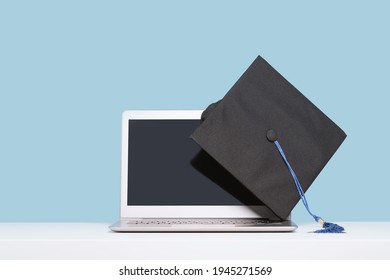 Black Graduation Cap With On Laptop. Masters Or Bachelors Degree Thesis Writing. Knowledge Online Courses Qualifications And Higher Education With Copy Space. Lockdown