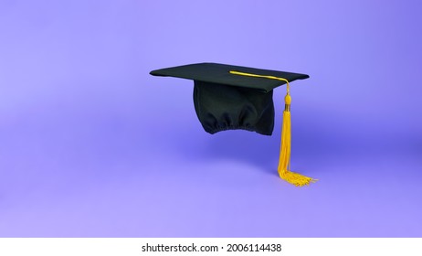 Black Graduation Cap On A Purple Background. The Concept Of Back To School. Black Mortar Board Cap. Graduation Web Banner Background.