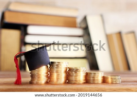 Black Graduation cap over stack of coins
