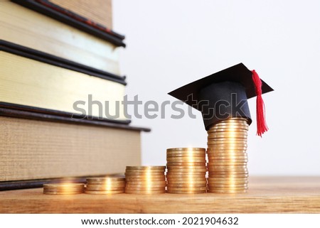 Black Graduation cap over stack of coins