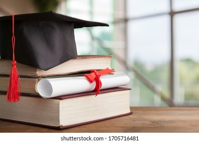Black Graduation Hat With Diploma And Book
