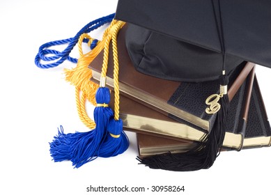 A Black Graduation Hat With Tassel And 2009 On A Stack Of Books With Blue And Gold Honors Cords, On White With Copy Space