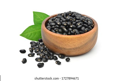  Black gram (Vigna mungo) in wooden bowl with green leaves  isolated on white background. 