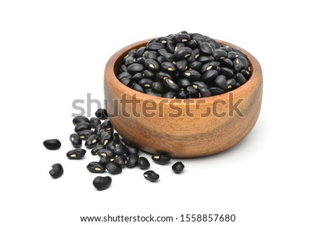  Black gram (Vigna mungo) in wooden bowl isolated on white background. 