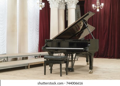 Black grand piano on stage