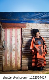 Black Grandma Laughing While Wearing Her Traditional Clothes.