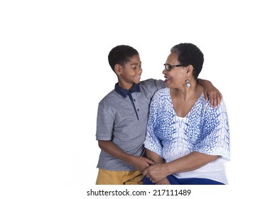 Black Grandmother And Grandson Smiling At Each Other Isolated On White