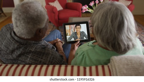 Black Grandparents Video Chatting With Granddaughter On Tablet